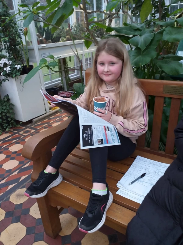 Young girl sitting on Conservatory bench